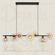 Suspension Olsen Searchlight 7 Lumières - Noir Mat et Double Verre Côtelé