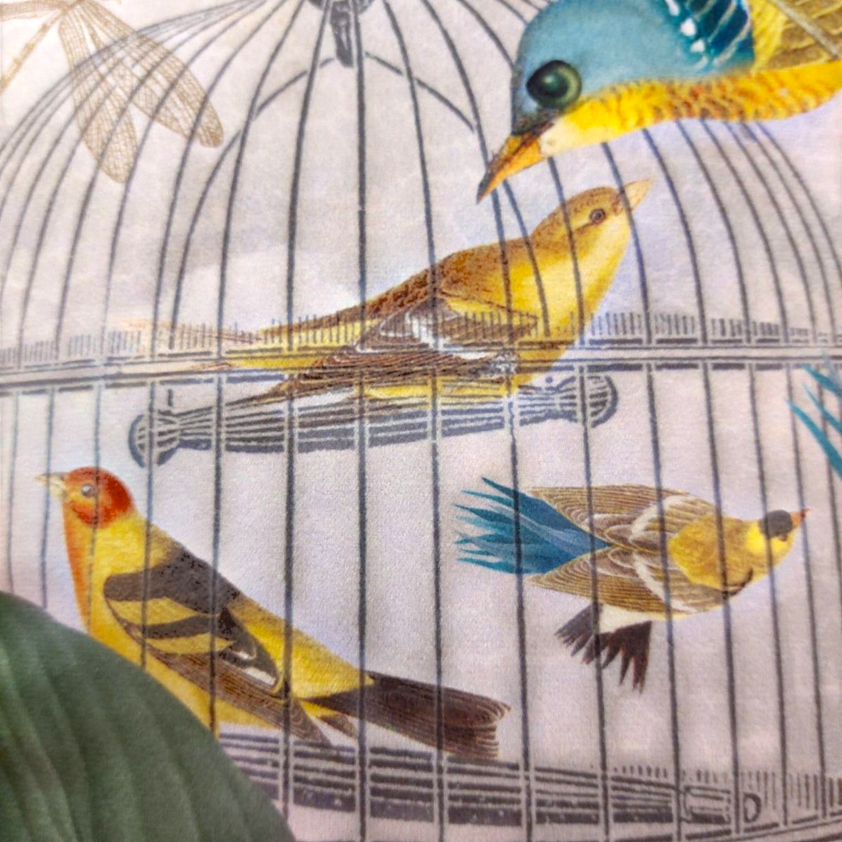 Depuis des lustres velvet cushion featuring vintage botanical bird and cage print in powder pink, yellow, and blue