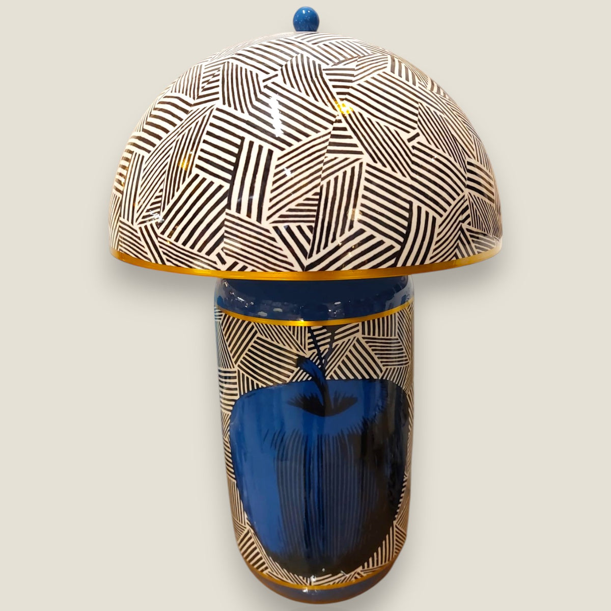 Depuis des lustres DRIMMER ceramic table lamp with blue apple motif, geometric dome shade, and gold trim details.