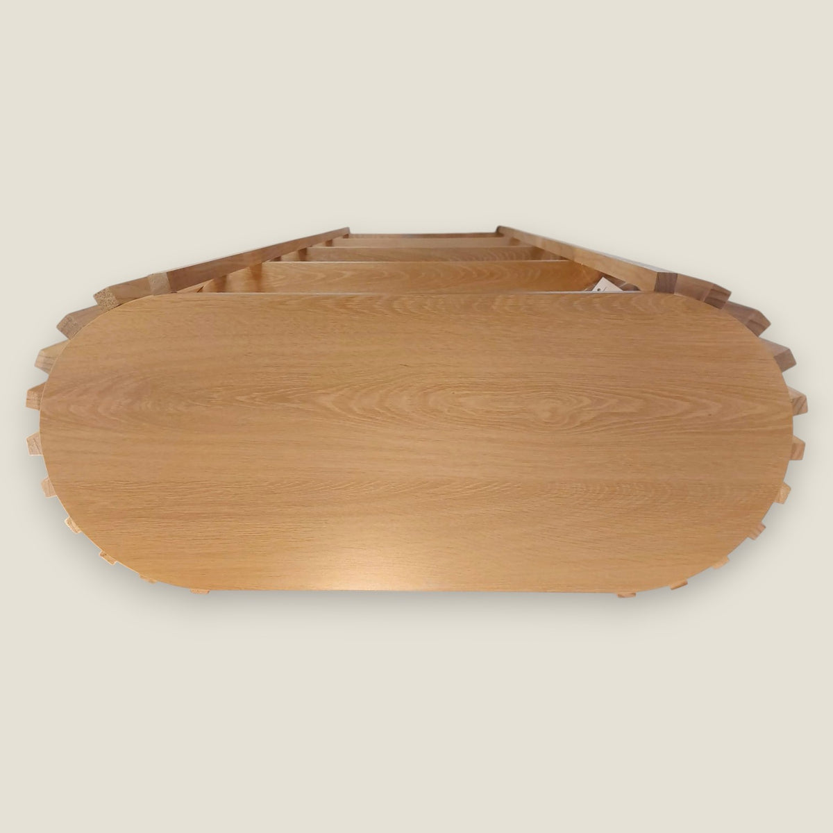 Depuis des lustres oval wooden slatted shelf with multiple tiers and a contemporary natural design