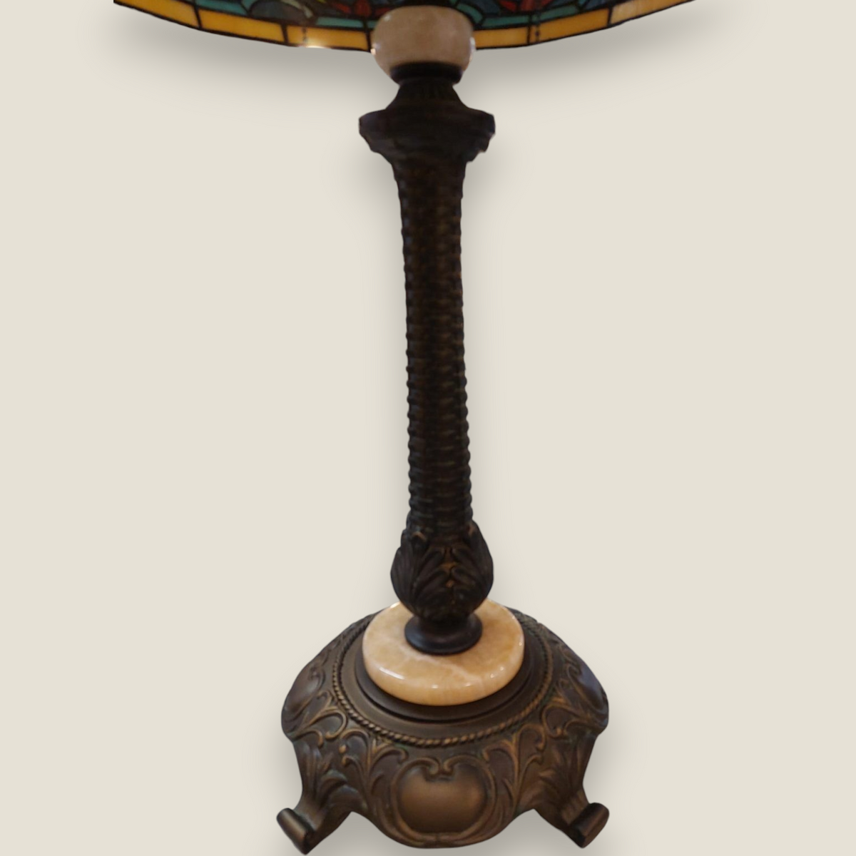 Depuis des lustres Tiffany lamp with a twisted bronze base, marble ring, and intricate floral stained glass shade.