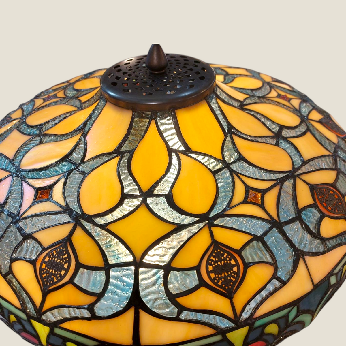 Depuis des lustres Tiffany style lamp shade with amber, teal, and orange stained glass floral patterns and bronze cap