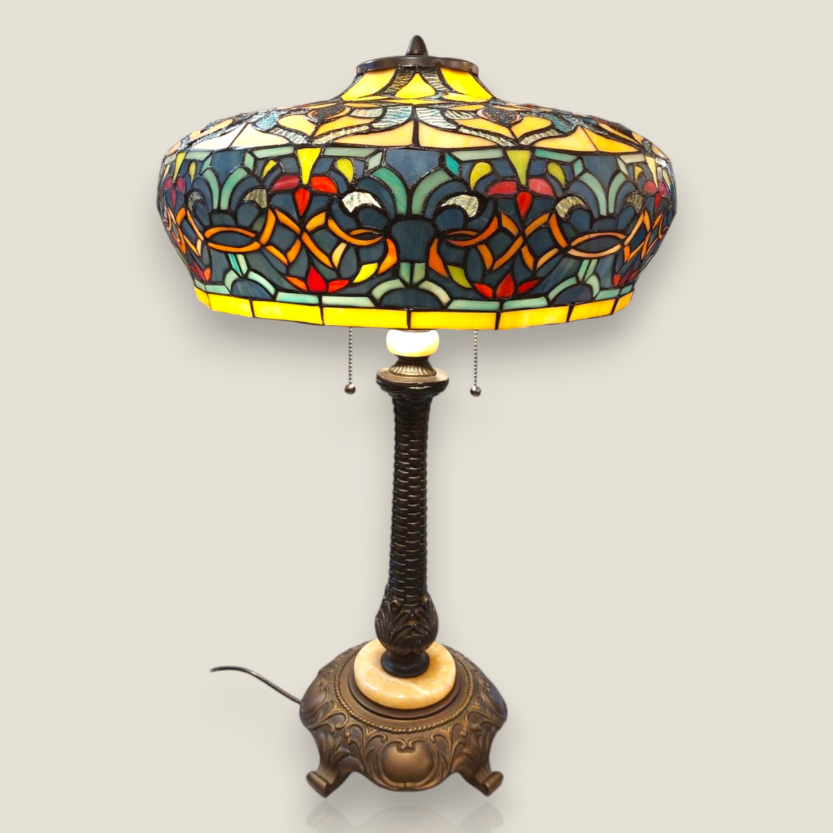 Depuis des lustres Tiffany style table lamp with a stained glass shade featuring floral patterns and bronze base.