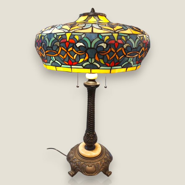 Depuis des lustres Tiffany style table lamp with a stained glass shade featuring floral patterns and bronze base.