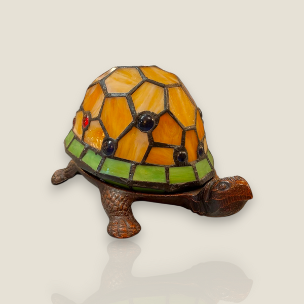 Depuis des lustres Tiffany style turtle lamp with amber and green stained glass shell and bronze metal base.