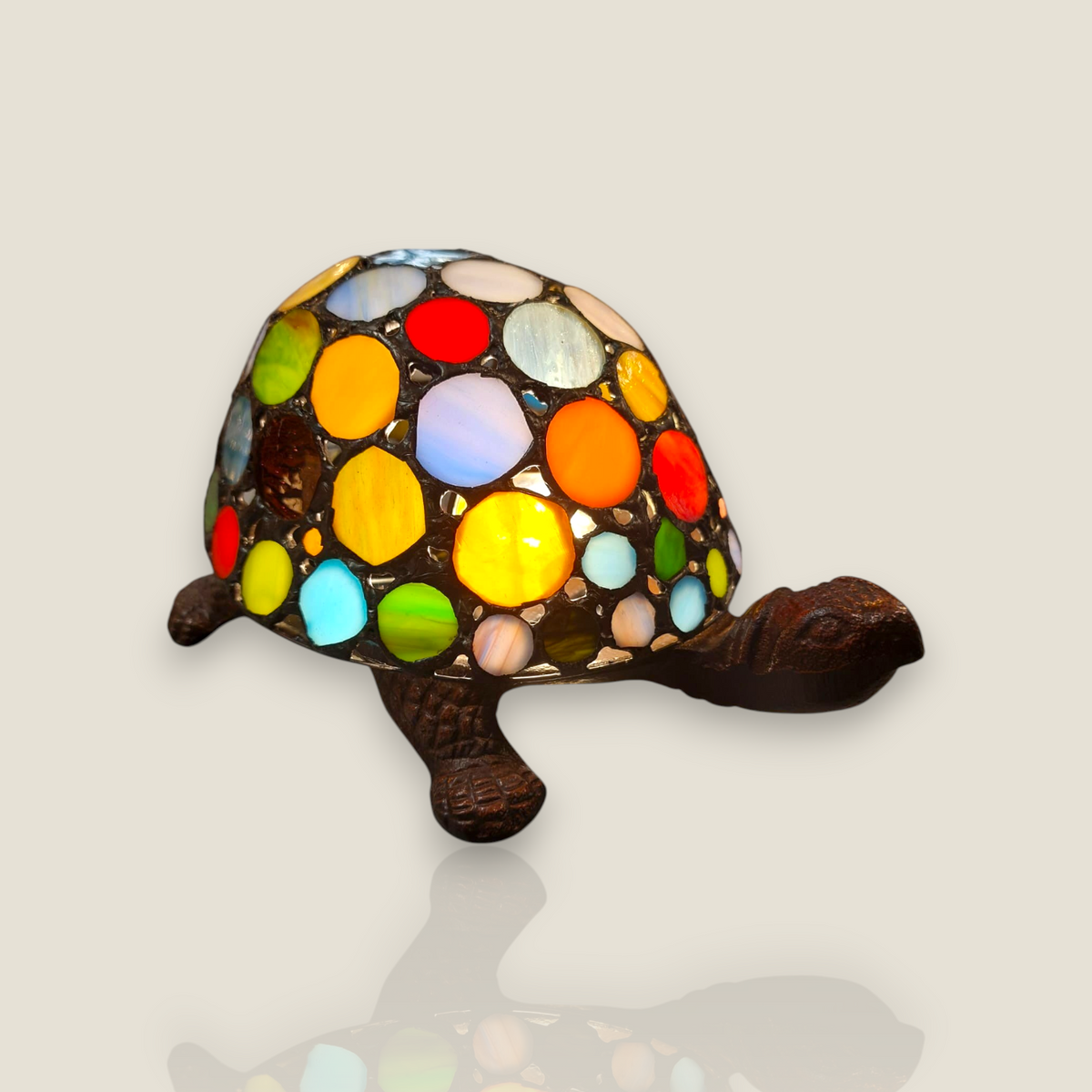 Depuis des lustres Tiffany style turtle lamp with a colorful stained glass shell and bronze-toned resin body.
