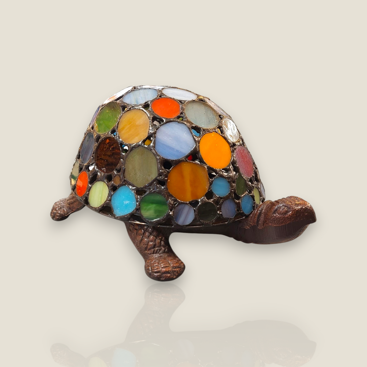 Depuis des lustres Tiffany style turtle lamp with a multicolored stained glass shell and bronze resin body.