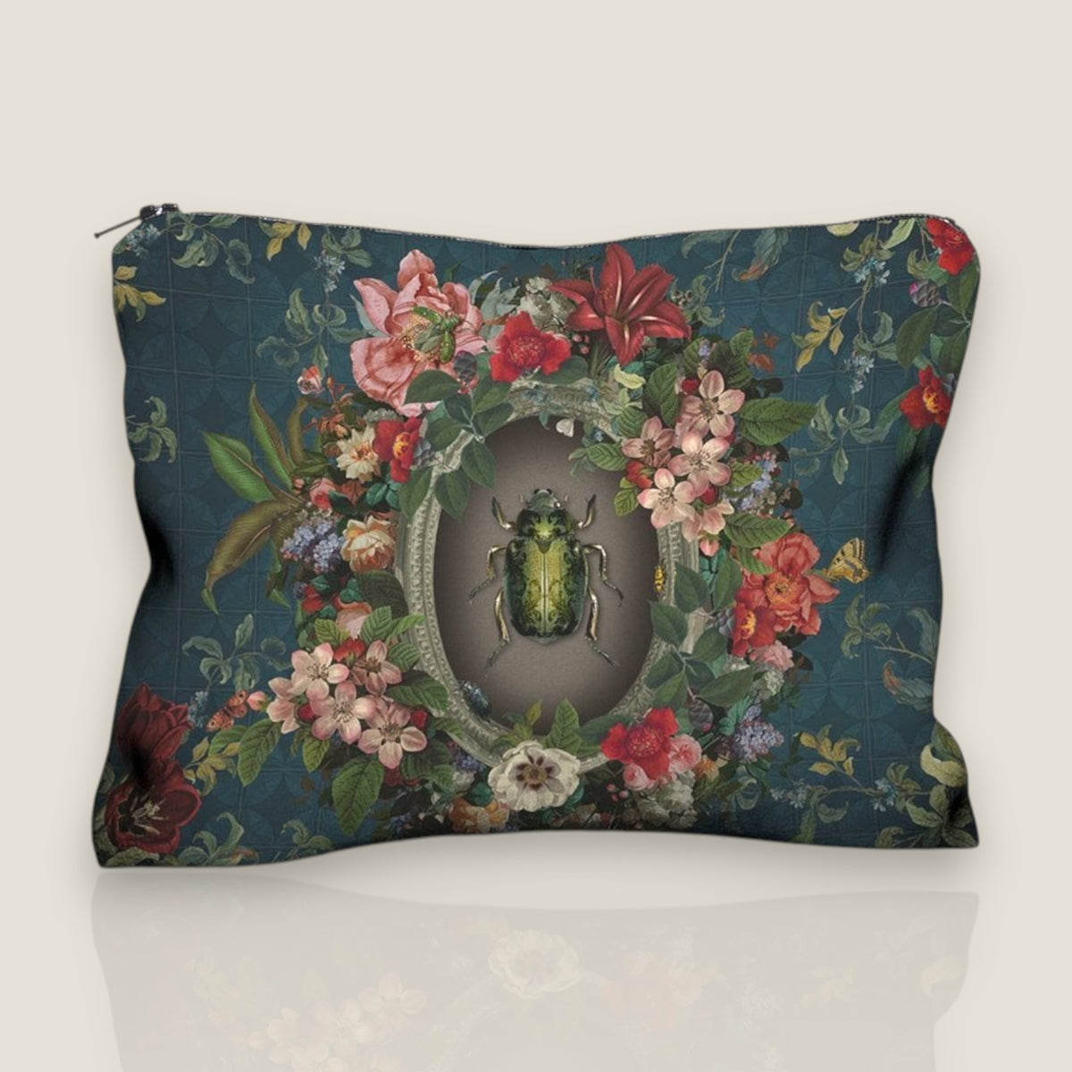 Depuis des lustres velvet pouch featuring a golden beetle in a floral wreath on a peacock blue background.