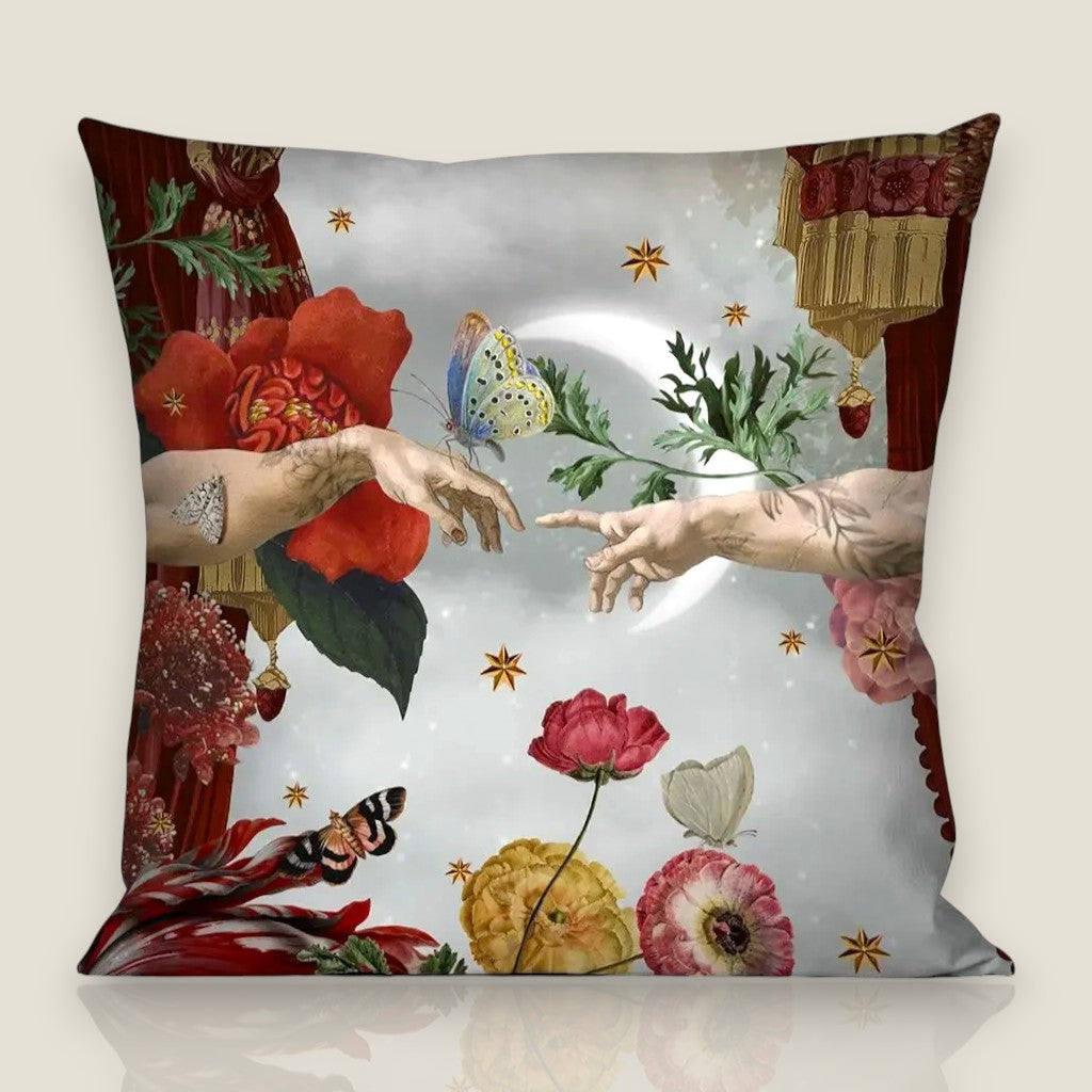 Depuis des lustres velvet cushion featuring The Creation of Adam with floral, bird, and star motifs and black piping.