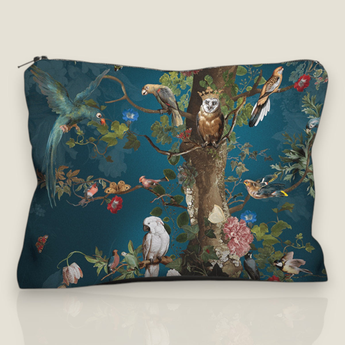 Depuis des lustres velvet pouch featuring a Tree of Life print with exotic birds and flowers on a deep blue background.