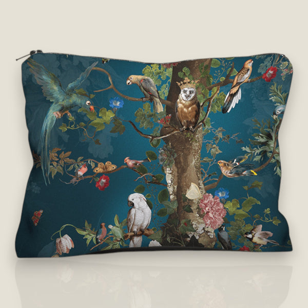 Depuis des lustres velvet pouch featuring a Tree of Life print with exotic birds and flowers on a deep blue background.
